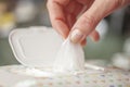 Hand picked a wet wipes in package box, Wet wipes in a woman& x27;s hand Royalty Free Stock Photo