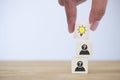 Hand picked wooden cube block, light bulb icon on top of human head icon to show concept creative idea Royalty Free Stock Photo