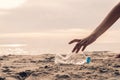 Hand picking bottle plastic on the beach Royalty Free Stock Photo