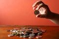 Hand picking a coin from a Bunch of loose change or coins Royalty Free Stock Photo