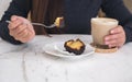 A hand picking dessert to eat with fork and a coffee cup on table Royalty Free Stock Photo