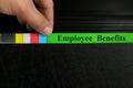 Hand picking employee benefits file in black binder folder. Human resources business concept. Royalty Free Stock Photo