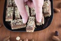 Hand picking piece of walnut cake from a plate Royalty Free Stock Photo