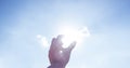 Hand picking sun at blue sky and cloud Royalty Free Stock Photo