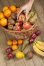 Hand picking up an apple from basket Royalty Free Stock Photo