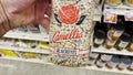 Hand picking up Camellia Blackeye peas in a bag in a grocery store