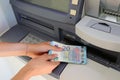 hand picking up money in European banknotes from an ATM bank cas Royalty Free Stock Photo