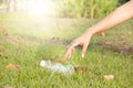 Hand picking up plastic bottle cleaning on the park