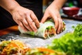 hand picking up a precut vietnamese spring roll showing inside filling Royalty Free Stock Photo