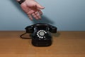 hand picks up the phone. old telephone set on a wooden table Royalty Free Stock Photo