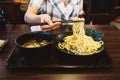 Hand pinching noodle before dipping in soup. Tsukemen is a ramen dish in Japanese cuisine consisting of noodles. Royalty Free Stock Photo