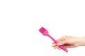 Hand with pink culinary brush, kitchen utensil Royalty Free Stock Photo