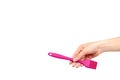 Hand with pink culinary brush, kitchen utensil Royalty Free Stock Photo