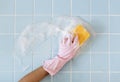 Hand in pink glove with sponge washing Royalty Free Stock Photo