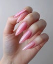 a hand with pink manicured nails