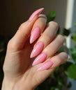 a hand with pink manicured nails