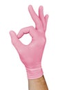 Hand in pink medical glove showing approval ok sign isolated on white background