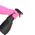 Hand in pink rubber glove holding black plastic spray detergent bottle. Household chemicals. Cleaning product