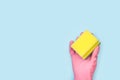 A hand with a pink rubber glove holding a cleaning sponge Royalty Free Stock Photo