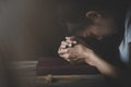 The hand placed on the Bible with his head bowed down. Pray to God. Praying for spiritual beliefs. The power of hope or love and Royalty Free Stock Photo