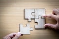 Hand placed the last piece of jigsaw puzzle, conceptual of problem solving, finding a solution