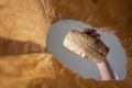 A hand places a paper-wrapped lunch in a paper bag. A mature man`s hand holds the food with him over the open brown bag.  Shot Royalty Free Stock Photo