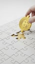Hand Placing Bitcoin Coin on Jigsaw Puzzle Royalty Free Stock Photo