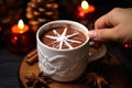 hand placing decorative star anise atop hot chocolate Royalty Free Stock Photo
