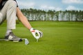 Hand placing golf ball on tee Royalty Free Stock Photo