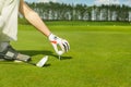 Hand placing golf ball on tee Royalty Free Stock Photo