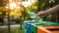 The hand placing a green bottle into a recycling bin in a park. AI generated image Royalty Free Stock Photo
