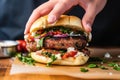 hand placing a grilled sausage in a bun