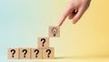 Hand Placing Idea Lightbulb Block on Stack of Question Blocks Royalty Free Stock Photo
