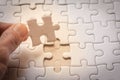 Hand placing the last jigsaw puzzle piece, Royalty Free Stock Photo