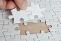 Hand placing missing jigsaw puzzle pieces. Solution concept Royalty Free Stock Photo