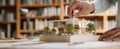 The hand placing a model of a modern house on a workspace..AI generated image Royalty Free Stock Photo