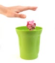 A hand placing paper in plastic bin Royalty Free Stock Photo