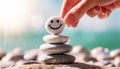 Hand Placing a Pebble with Smiling Face on Top of a Stack of Pebbles - Generative Ai Royalty Free Stock Photo
