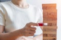Hand placing or pulling wooden block on the tower. Business planning, Decision, Risk Management, Solution and strategy Conceptual Royalty Free Stock Photo