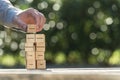 Hand placing wooden building blocks to success Royalty Free Stock Photo