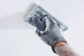 Plasterer polishing ceiling Royalty Free Stock Photo