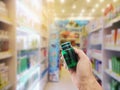 Hand with plastic pill bottle on pharmacy store Royalty Free Stock Photo