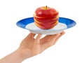 Hand with plate and chopped apple