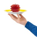 Hand with plate and chopped apple Royalty Free Stock Photo
