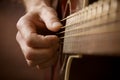 Hand playing acoustic guitar