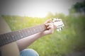 Hand playing on acoustic guitar in the nature Royalty Free Stock Photo