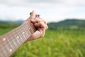 Hand playing on acoustic guitar in the nature Royalty Free Stock Photo