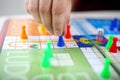 Hand is playing board ludo game