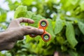 A hand playing with a fidget spinner. Royalty Free Stock Photo