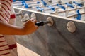 Hand playing foosball. People enjoying table soccer game Royalty Free Stock Photo